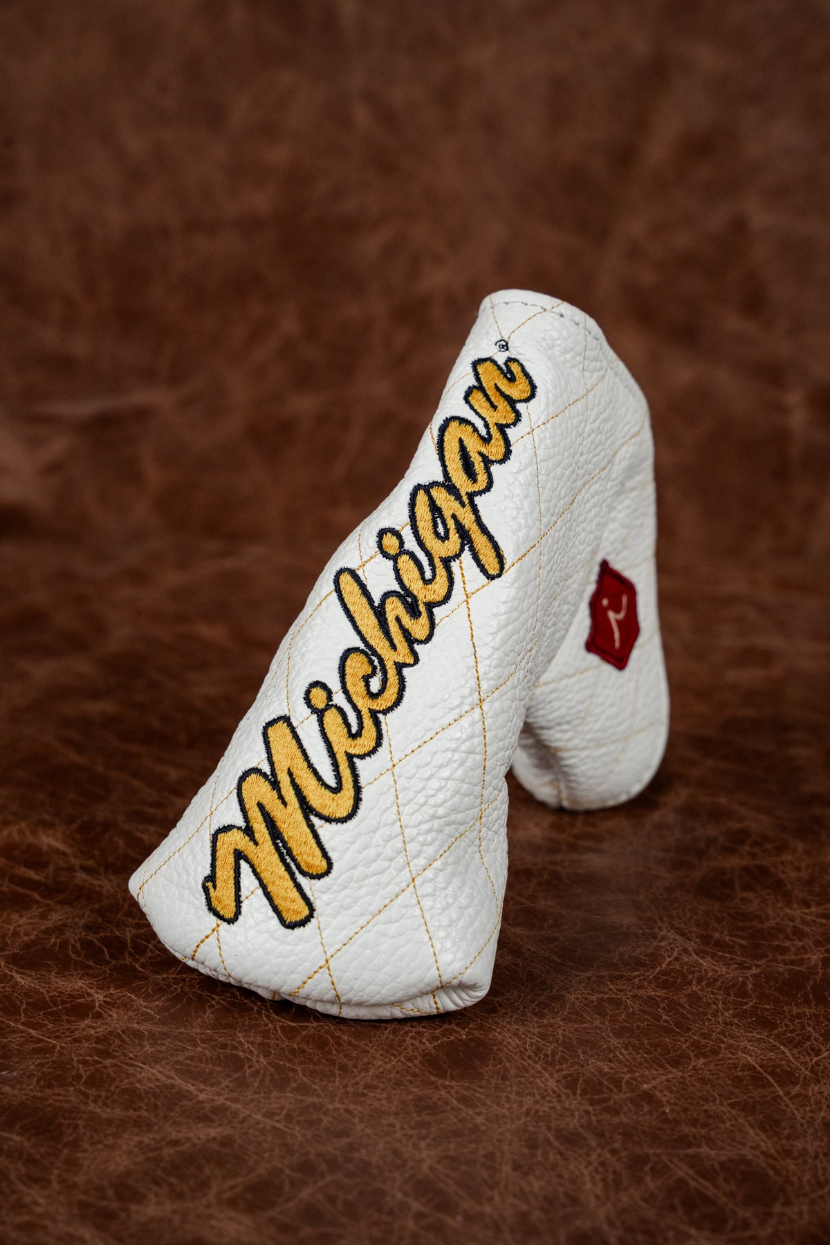 Oxblood quilted driver cover stitched Hennessy in cream, with gold piping