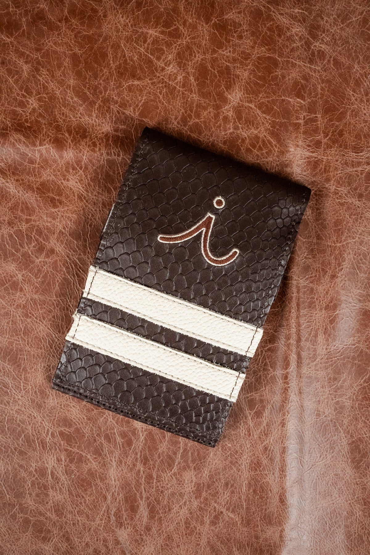 USA stitched in red across navy and white racing stripes