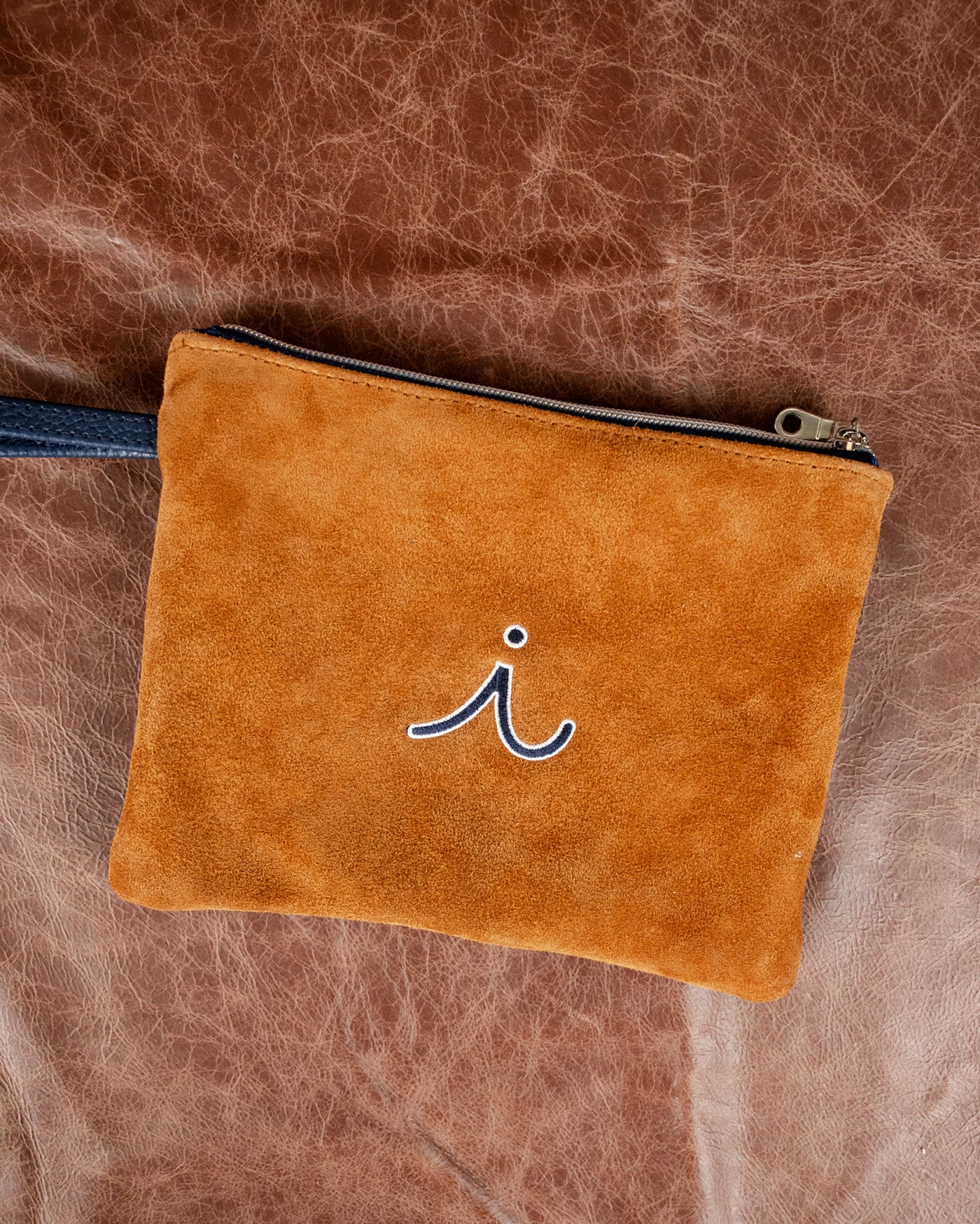 iliac Velora Fall Edition caramel suede clutch with embroidered i logo