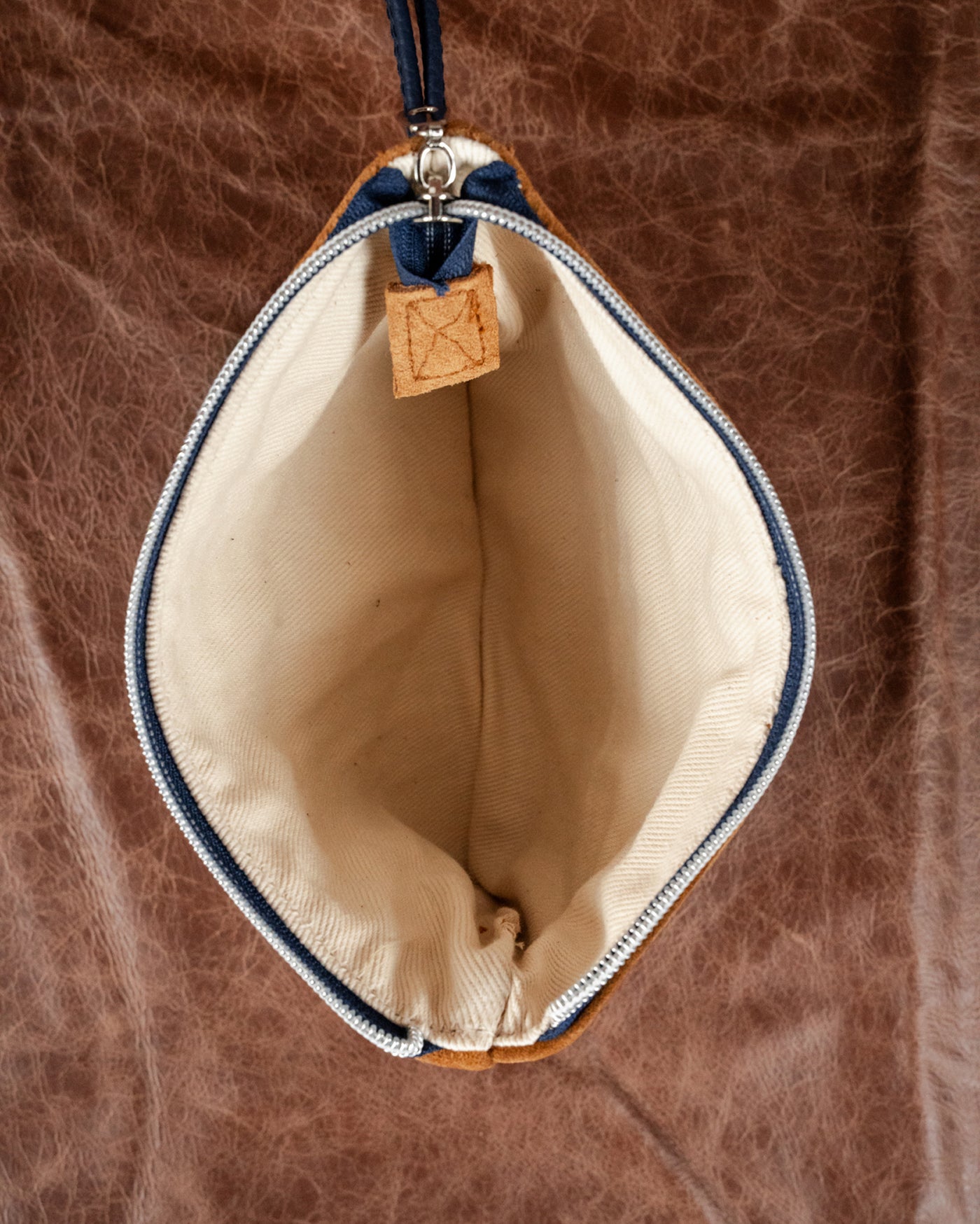 Open view of the Velora Fall Edition clutch showing cotton-lined interior
